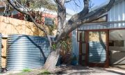 Slimline steel tank in a backyard galvanised